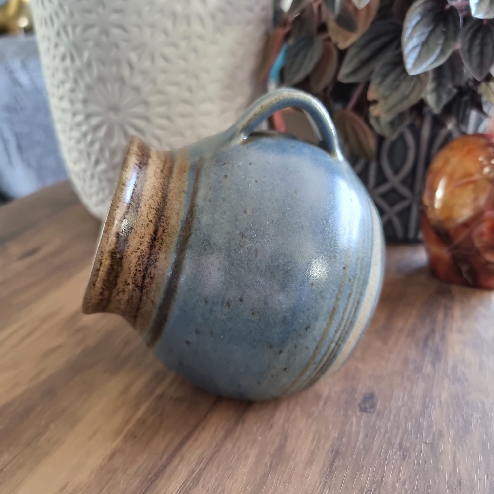Vintage stoneware salt pig with blue-brown glaze and side handle, perfect for storing flaky sea salt