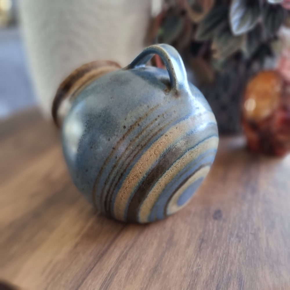 Vintage stoneware salt pig with blue-brown glaze and side handle, perfect for storing flaky sea salt