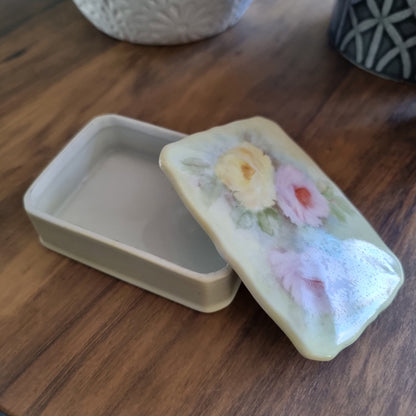 Porcelain trinket box with hand-painted pastel roses and scalloped edge lid.