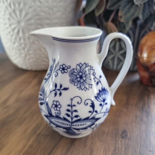 Czech Bohemian pottery jug with blue floral design on white ceramic and elegant curved handle

