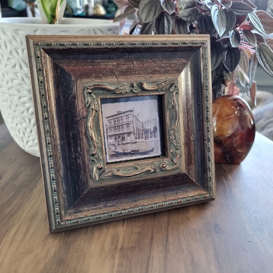 Ornate wood and gold photo frame with vintage Venice gondola print.