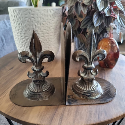 Pair of cast iron bookends with Fleur-de-Lis design and aged finish.