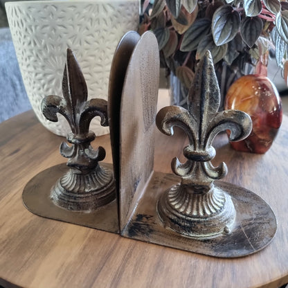 Pair of cast iron bookends with Fleur-de-Lis design and aged finish.