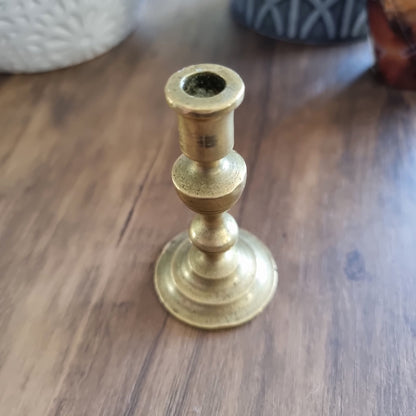 Small vintage brass candle holder with classic shape and tiered base.