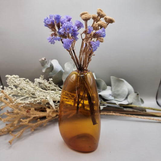 Amber handblown vase with smooth curved shape and small top opening.