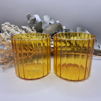 Pair of amber ribbed glass tumblers with ribbed detail.