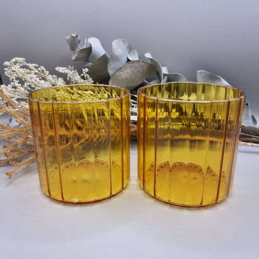 Pair of amber ribbed glass tumblers with ribbed detail.