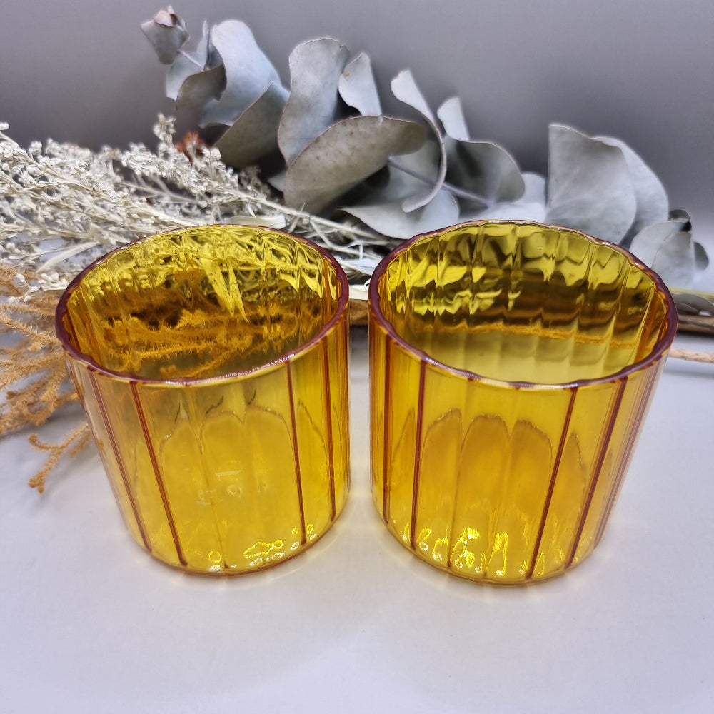 Pair of amber ribbed glass tumblers with ribbed detail.