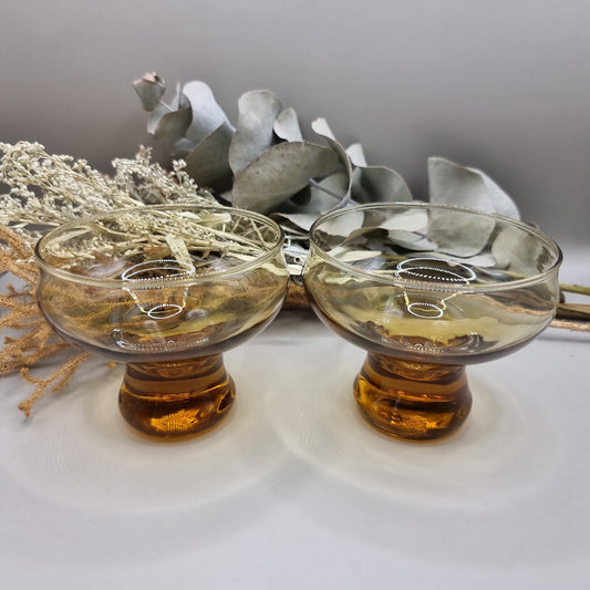 Pair of 1970s Kaaru Honeygold pedestal glasses in amber tint.