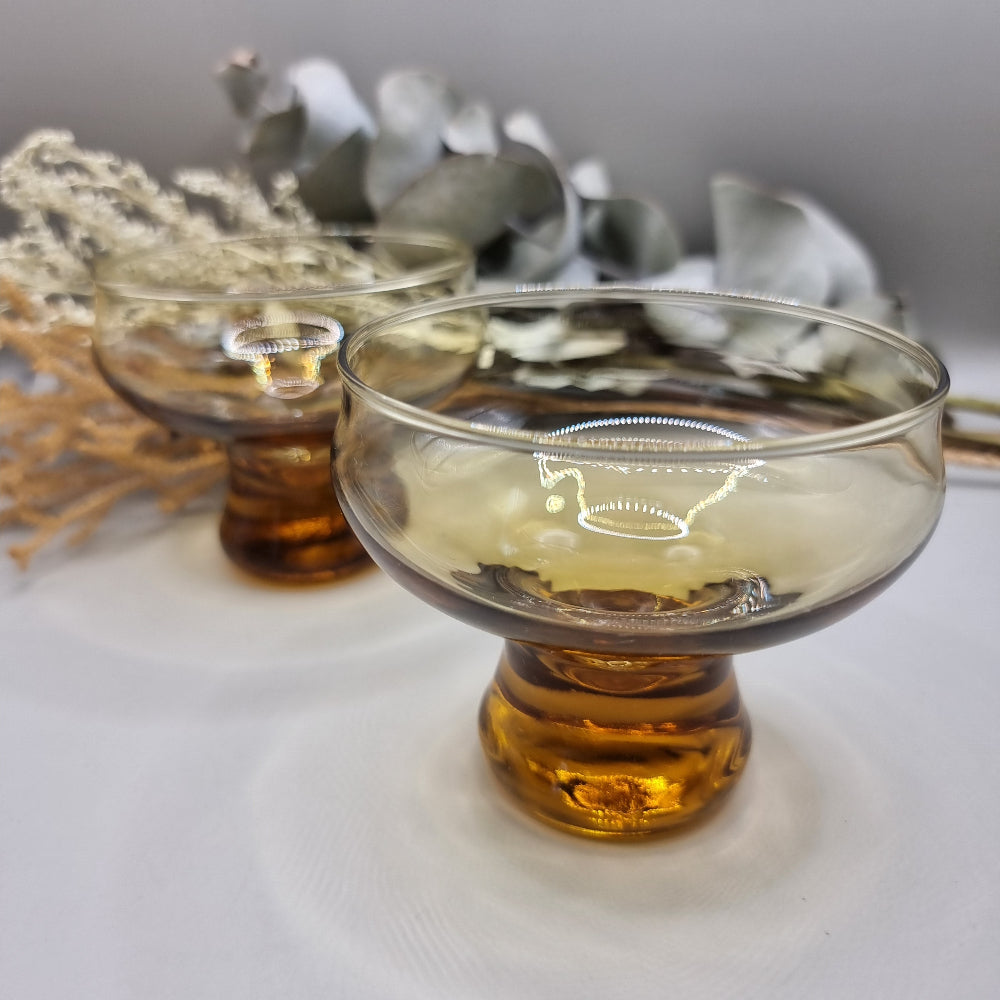 Pair of 1970s Kaaru Honeygold pedestal glasses in amber tint.