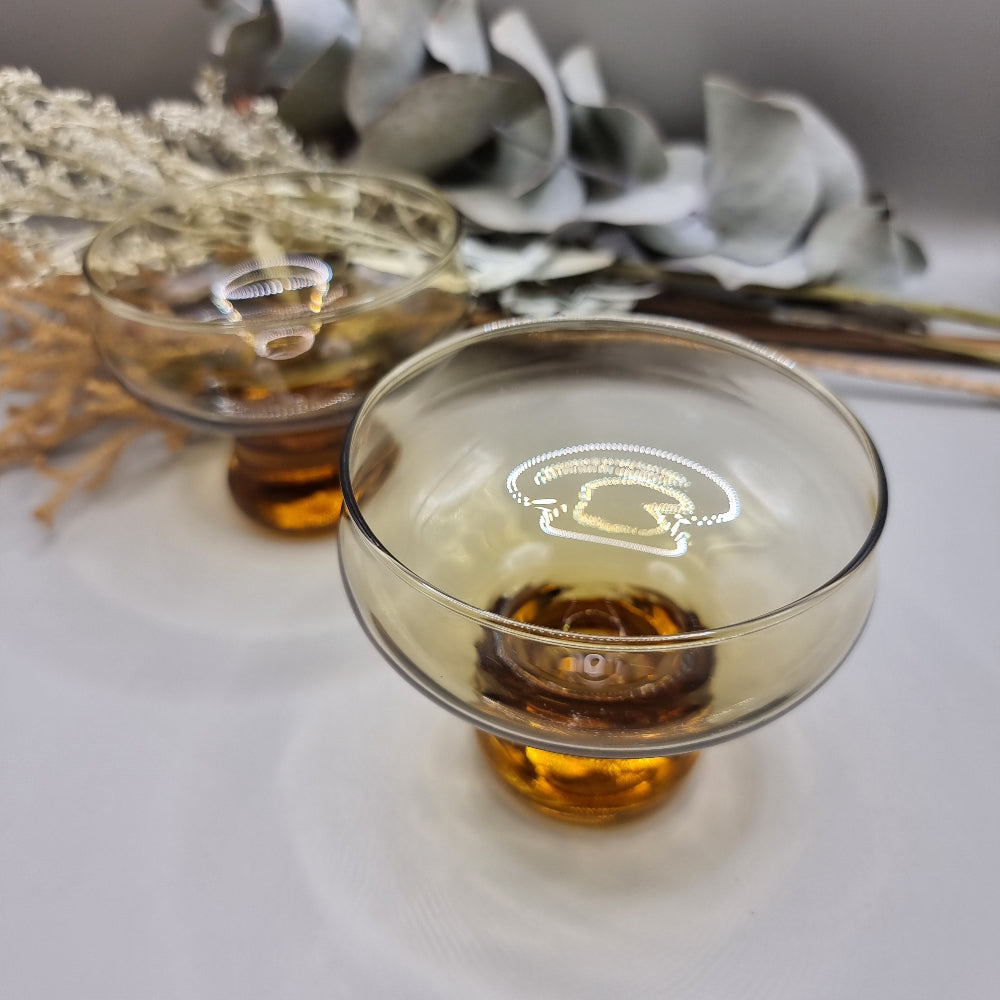 Pair of 1970s Kaaru Honeygold pedestal glasses in amber tint.