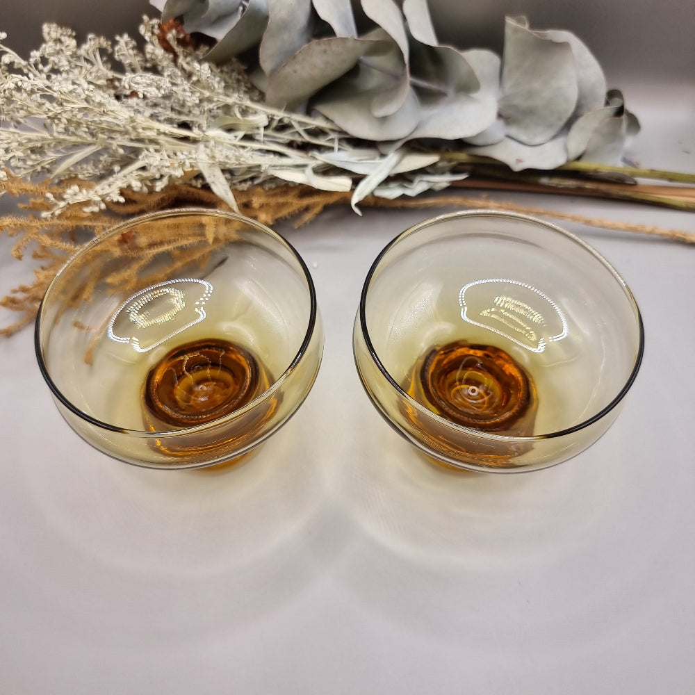 Pair of 1970s Kaaru Honeygold pedestal glasses in amber tint.
