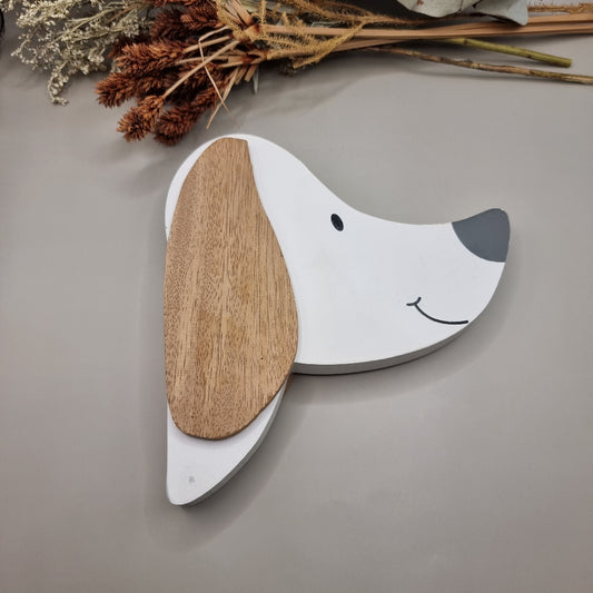 Cute wooden dog face wall hooks with clothes hanging from the nose hook.