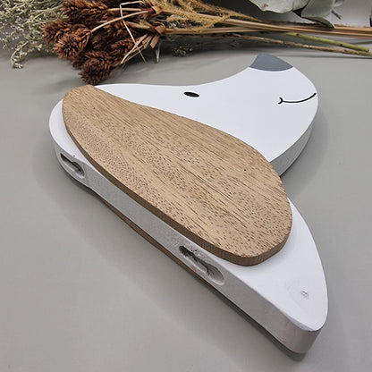 Cute wooden dog face wall hooks with clothes hanging from the nose hook.