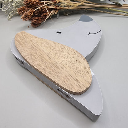 Cute wooden dog face wall hooks with clothes hanging from the nose hook.