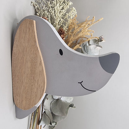 Cute wooden dog face wall hooks with clothes hanging from the nose hook.
