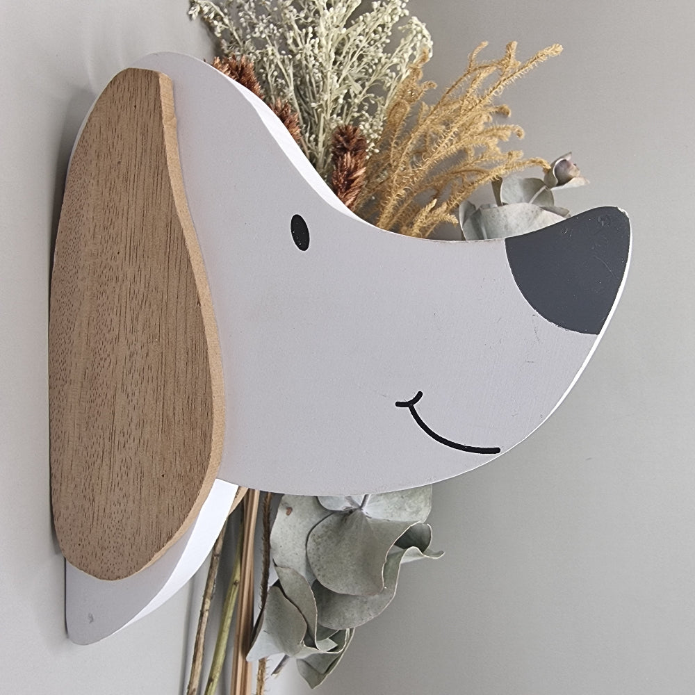 Cute wooden dog face wall hooks with clothes hanging from the nose hook.