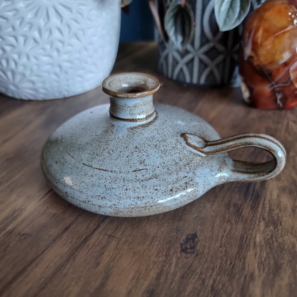 Krums speckled stoneware candle holder with side loop handle and earthy neutral glaze.