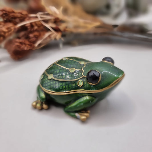 Green enamel frog trinket box with gold trim and rhinestones.