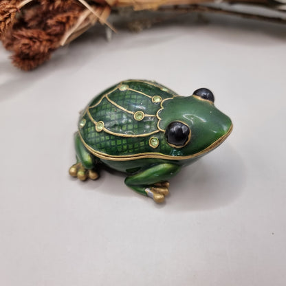 Green enamel frog trinket box with gold trim and rhinestones.