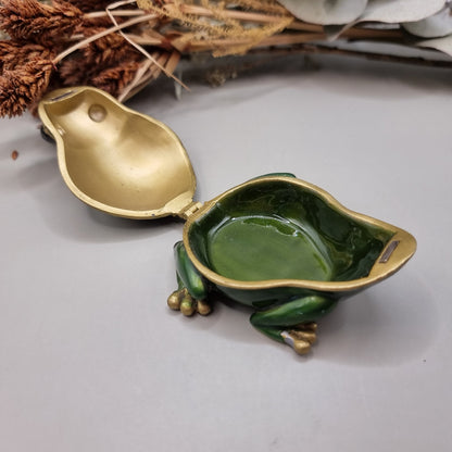 Green enamel frog trinket box with gold trim and rhinestones.