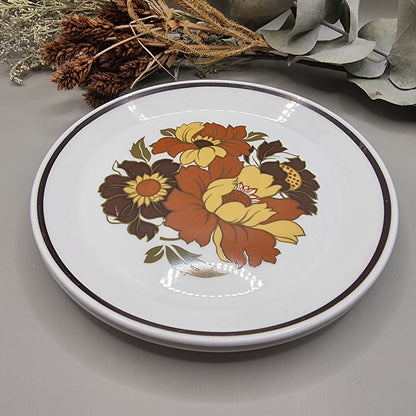 Set of two dinner plates with large 70s floral design in orange, yellow and brown