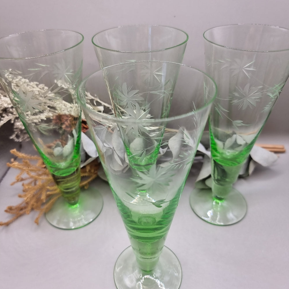 Set of 4 tall green etched flutes with starburst and leaf design.