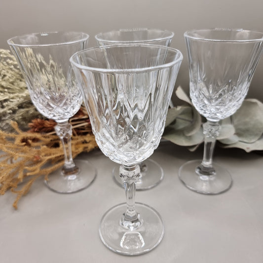 Set of four cut crystal goblets with faceted stems and traditional crisscross pattern

