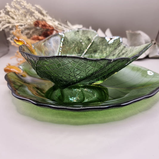 Green glass Dynasty Gallery olive leaf bowl and plate with gold stem detail.