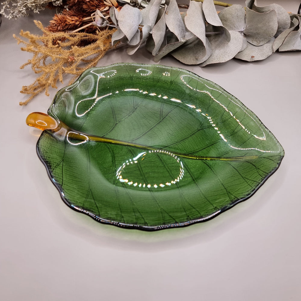 Green glass Dynasty Gallery olive leaf bowl and plate with gold stem detail.