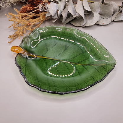 Green glass Dynasty Gallery olive leaf bowl and plate with gold stem detail.