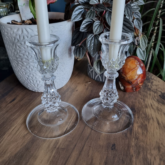 Pair of clear cut glass candlesticks with diamond pattern and flared base
