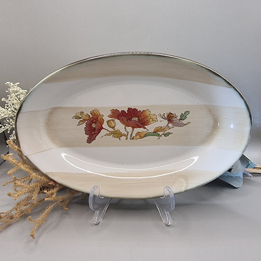 Robert Gordon oval stoneware plate with red poppies and beige bands.