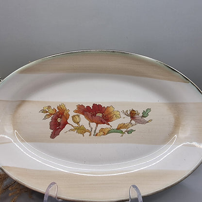 Robert Gordon oval stoneware plate with red poppies and beige bands.