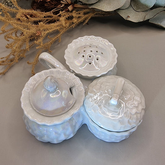 Sparkling vintage ceramic condiment set with pearly glaze. Lidded pots and shaker with central handle.