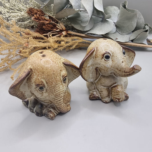 Vintage ceramic elephant salt and pepper shakers with speckled glaze and sweet expressions.