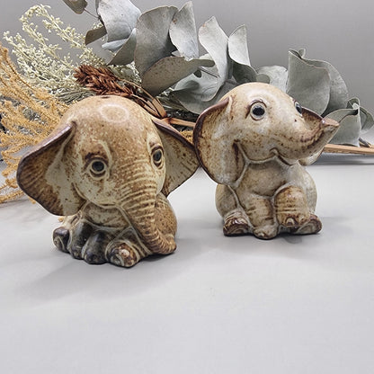 Vintage ceramic elephant salt and pepper shakers with speckled glaze and sweet expressions.