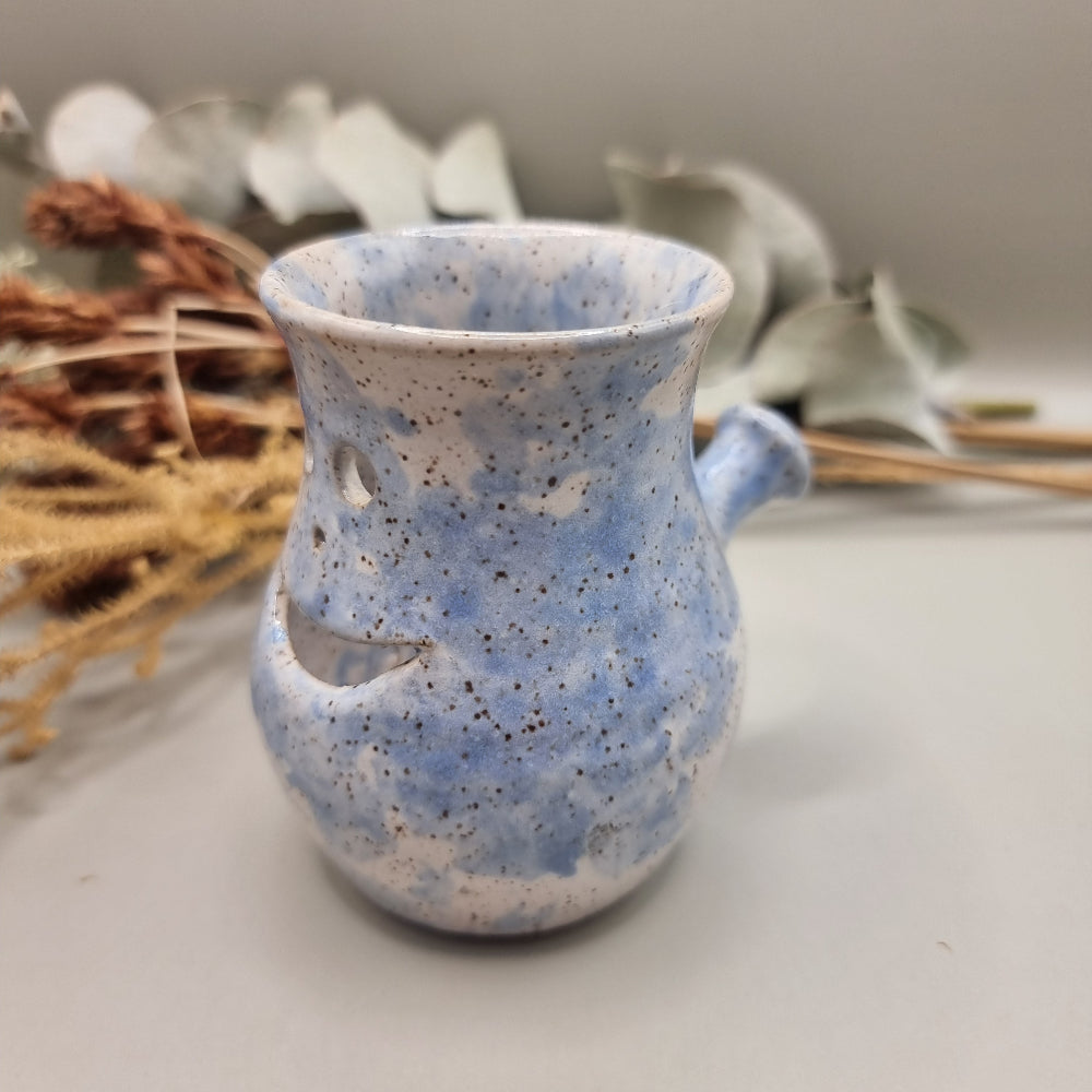 Vintage pottery face jug with blue speckle glaze and smiling face