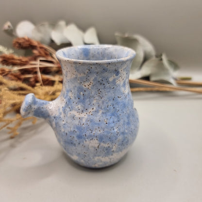 Vintage pottery face jug with blue speckle glaze and smiling face