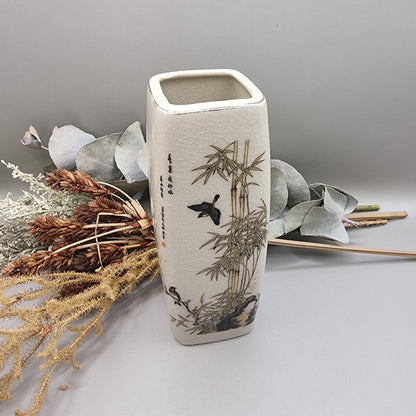 Vintage oriental-style ceramic vase with bamboo and bird design on crackle glaze.