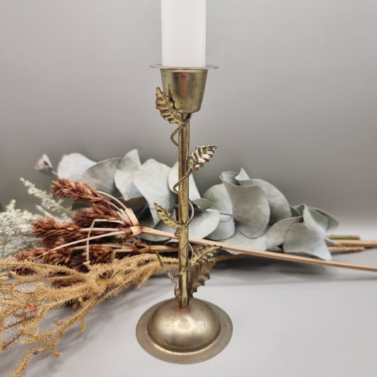 Brass tone metal candle holder with climbing vine and leaf detail.