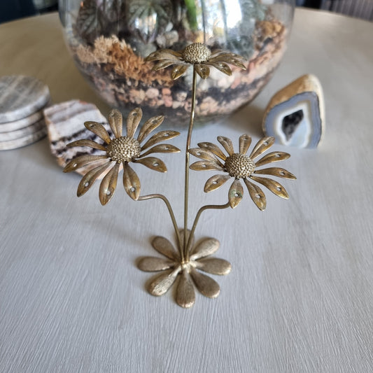 Vintage brass earring holder with three daisy flowers and petal holes for displaying earrings.