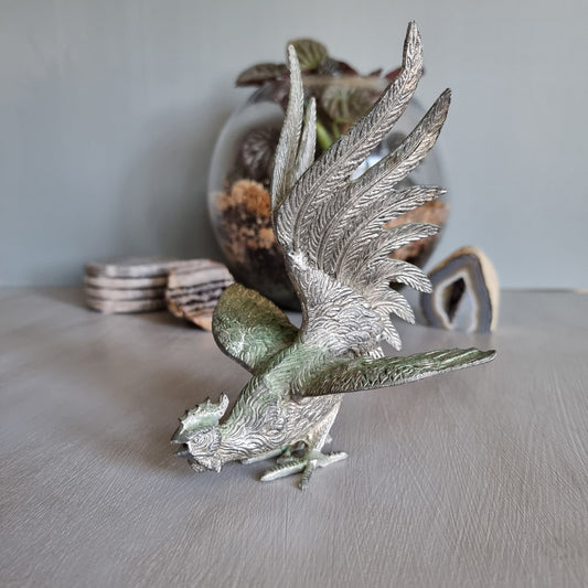 Metal rooster figurine with green patina, raised wings and detailed feathers, Japanese decor.