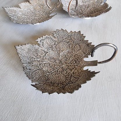 Set of 3 silver-toned metal leaf-shaped dishes with intricate engraved floral patterns