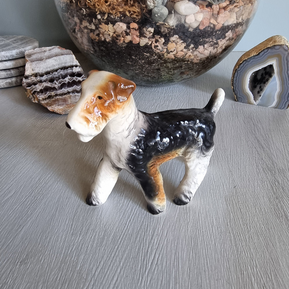 Vintage ceramic wire fox terrier figurine with glossy black and tan coat.