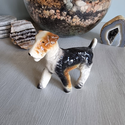 Vintage ceramic wire fox terrier figurine with glossy black and tan coat.
