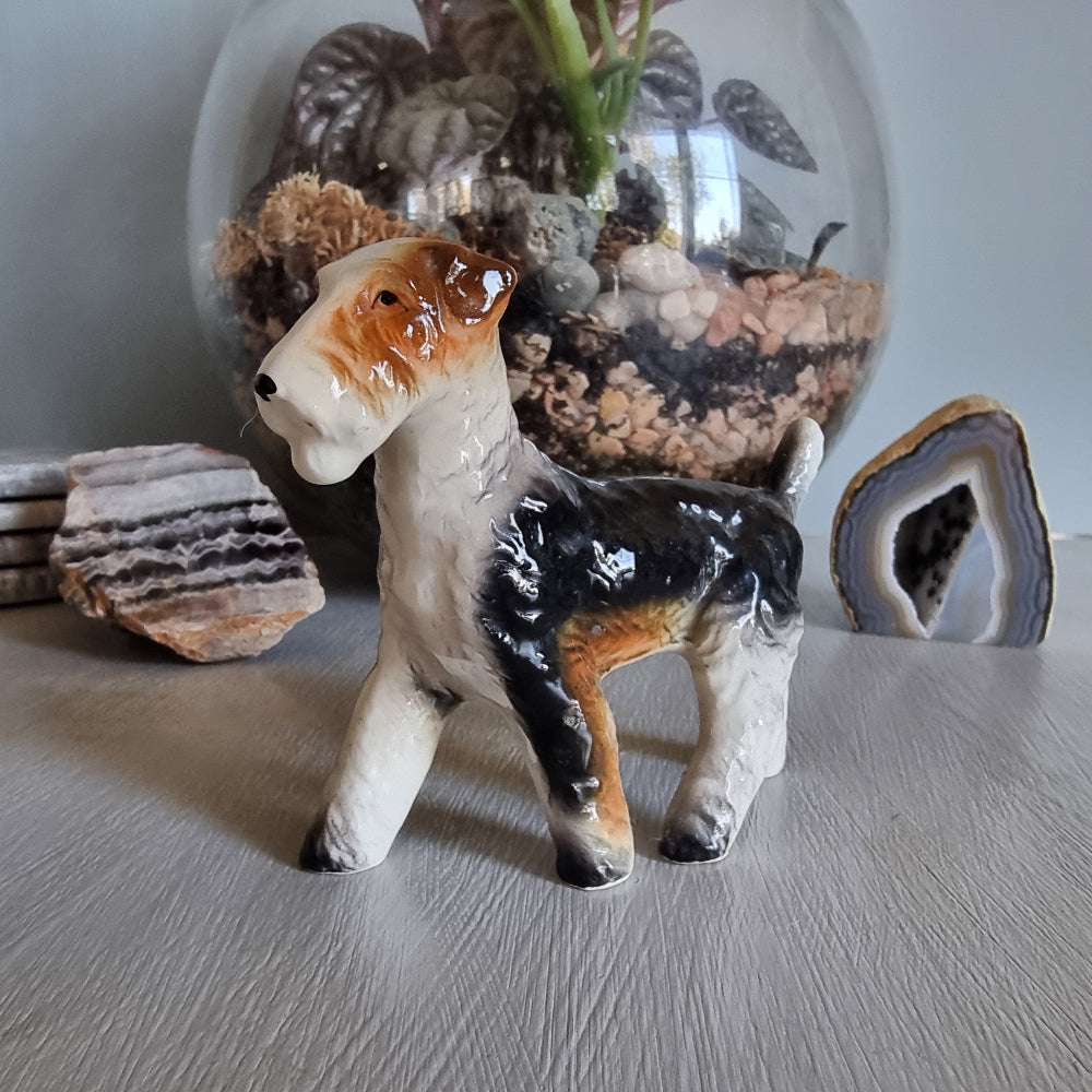 Vintage ceramic wire fox terrier figurine with glossy black and tan coat.