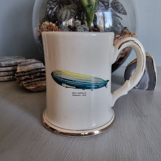 Vintage mug with Graf Zeppelin and Viking ship illustrations, gold trim and crackle glaze.