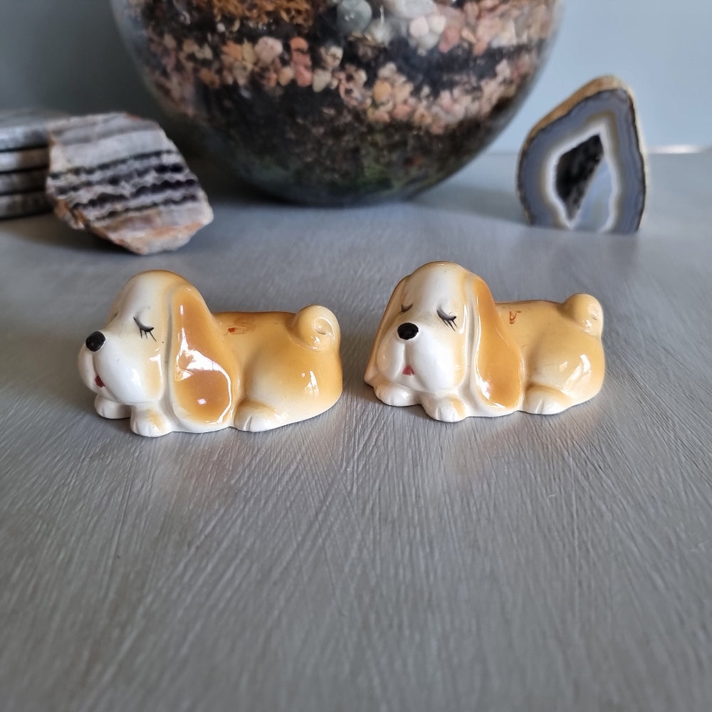 Pair of vintage sleeping dog salt and pepper shakers in caramel and white glaze.