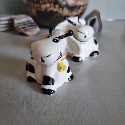 Ceramic cow salt and pepper shakers with black spots and yellow cowbells